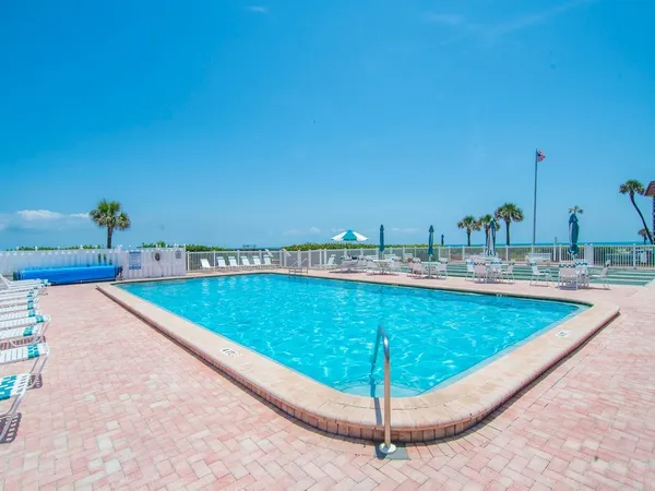 a view of a swimming pool with a lounge chairs
