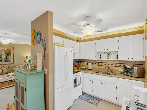 a kitchen with a refrigerator a sink and dishwasher
