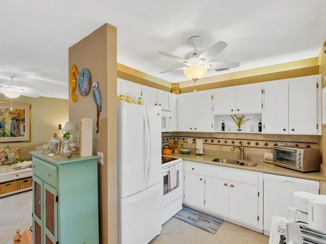 a kitchen with a refrigerator a sink and dishwasher