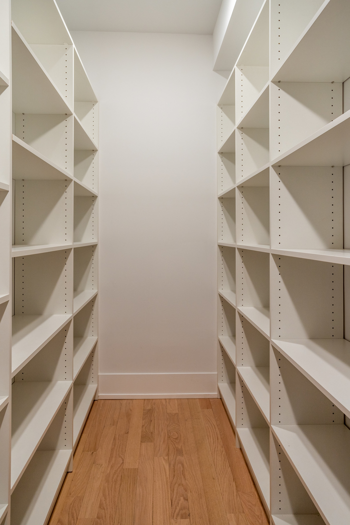 2228 West Lyndale Street Chicago, IL 60647 - Photo 9 of 23 a view of walk in closet with empty racks