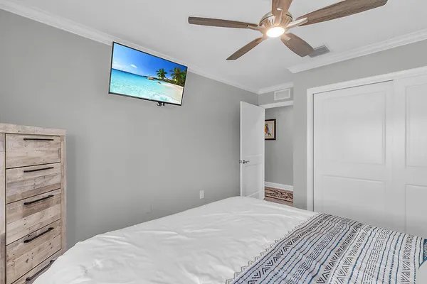 a bedroom with a bed and a painting on the wall