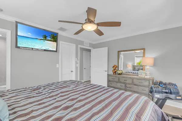 a bedroom with a bed and a chandelier