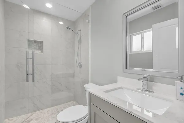 a bathroom with a sink toilet and shower