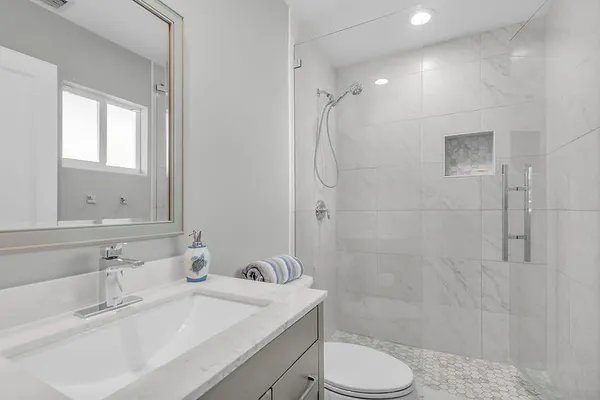 a bathroom with a sink toilet and shower