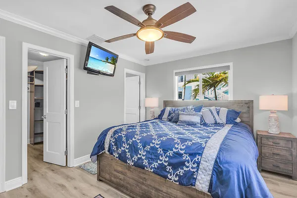 a bedroom with a bed and a chandelier