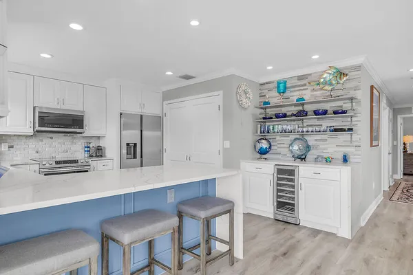 a kitchen with stainless steel appliances a refrigerator and stove top oven