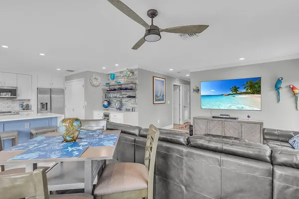 a living room with stainless steel appliances kitchen island granite countertop furniture and a kitchen view