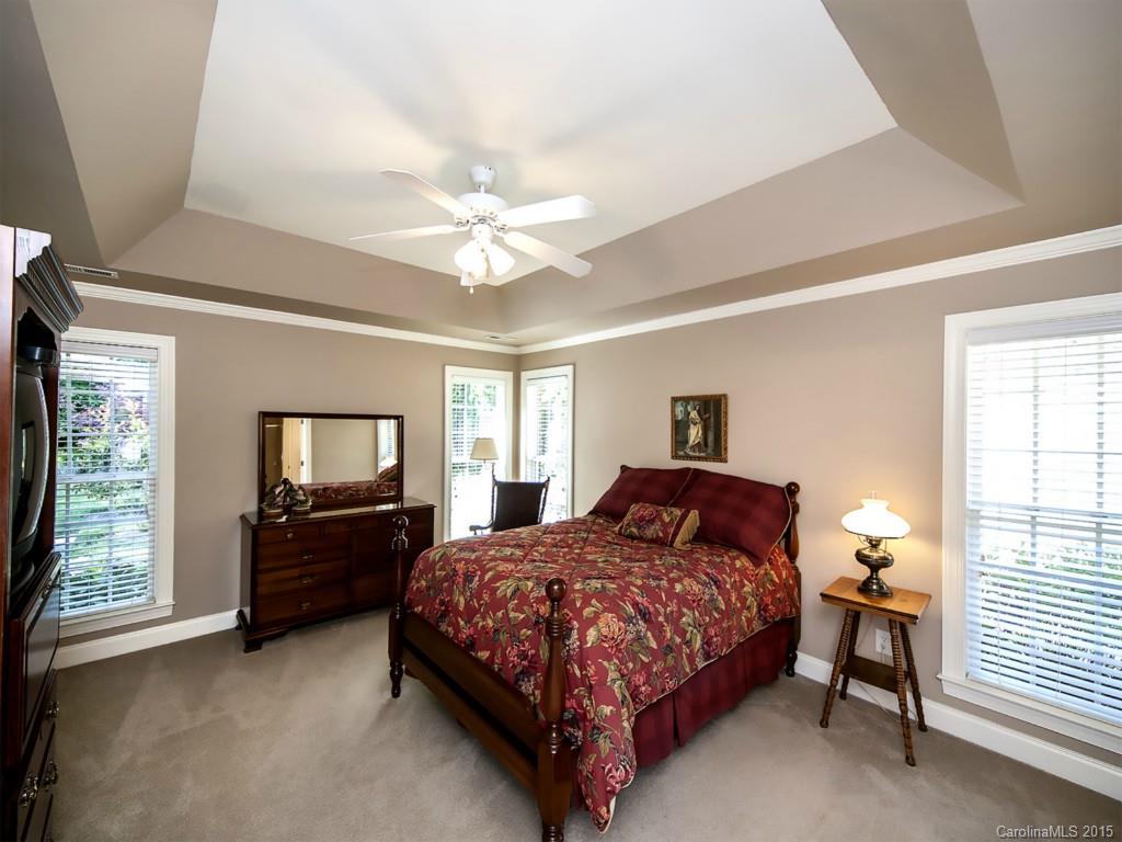 1327 Crown Ridge Drive Fort Mill, SC 29708 - Photo 14 of 22 a bedroom with a bed and a chandelier