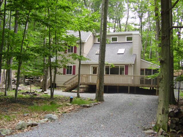 1214 Deer Run Road Pocono Lake, PA 18347 - Photo 1 of 1 a front view of a house with a yard and a tree