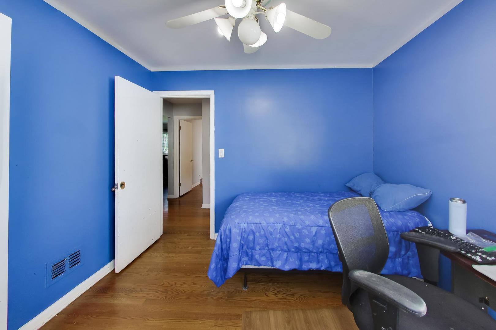 458 West Alma Street Elmhurst, IL 60126 - Photo 13 of 29 a bedroom with a chair and wooden floor