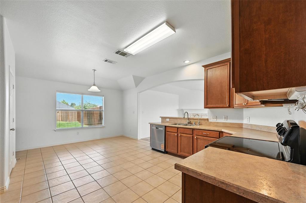 4312 Ridgewood Road Melissa, TX 75454 - Photo 14 of 40 a kitchen with stainless steel appliances a sink stove and cabinets
