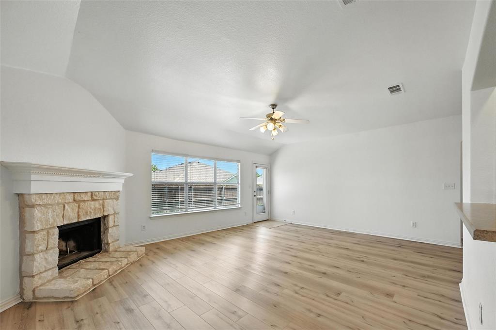 4312 Ridgewood Road Melissa, TX 75454 - Photo 20 of 40 an empty room with windows fireplace and wooden floor