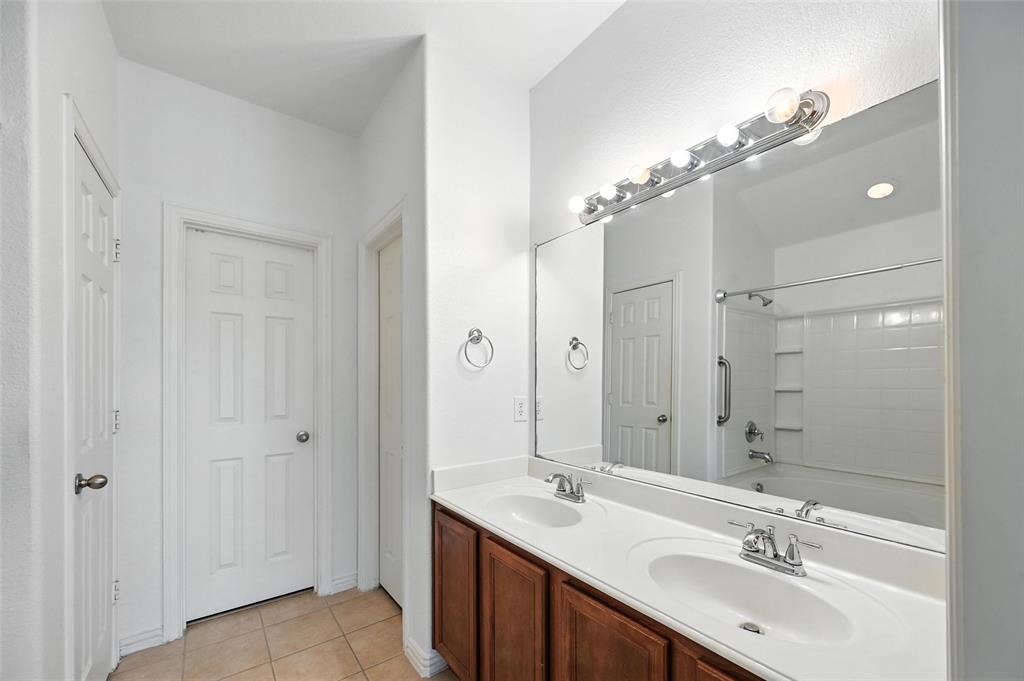 4312 Ridgewood Road Melissa, TX 75454 - Photo 26 of 40 a bathroom with a double vanity sink mirror and shower