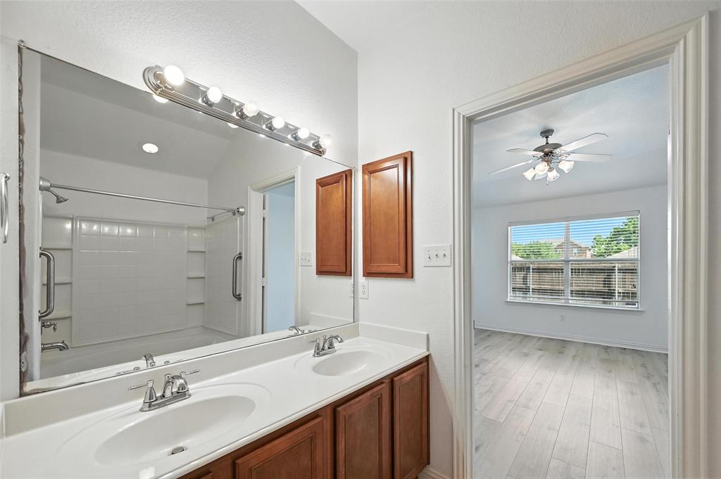 4312 Ridgewood Road Melissa, TX 75454 - Photo 27 of 40 a bathroom with a sink double vanity and a mirror