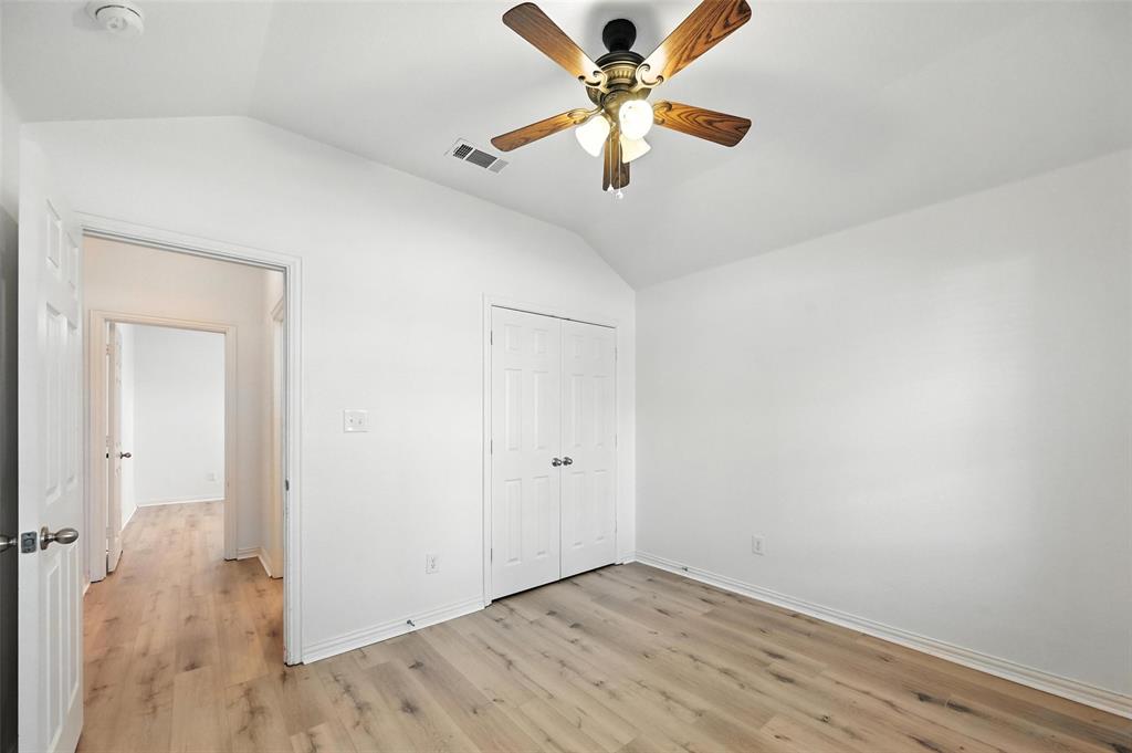 4312 Ridgewood Road Melissa, TX 75454 - Photo 4 of 40 an empty room with wooden floor fan and windows