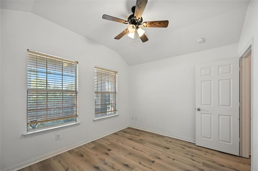 4312 Ridgewood Road Melissa, TX 75454 - Photo 5 of 40 a view of an empty room with a window and wooden floor
