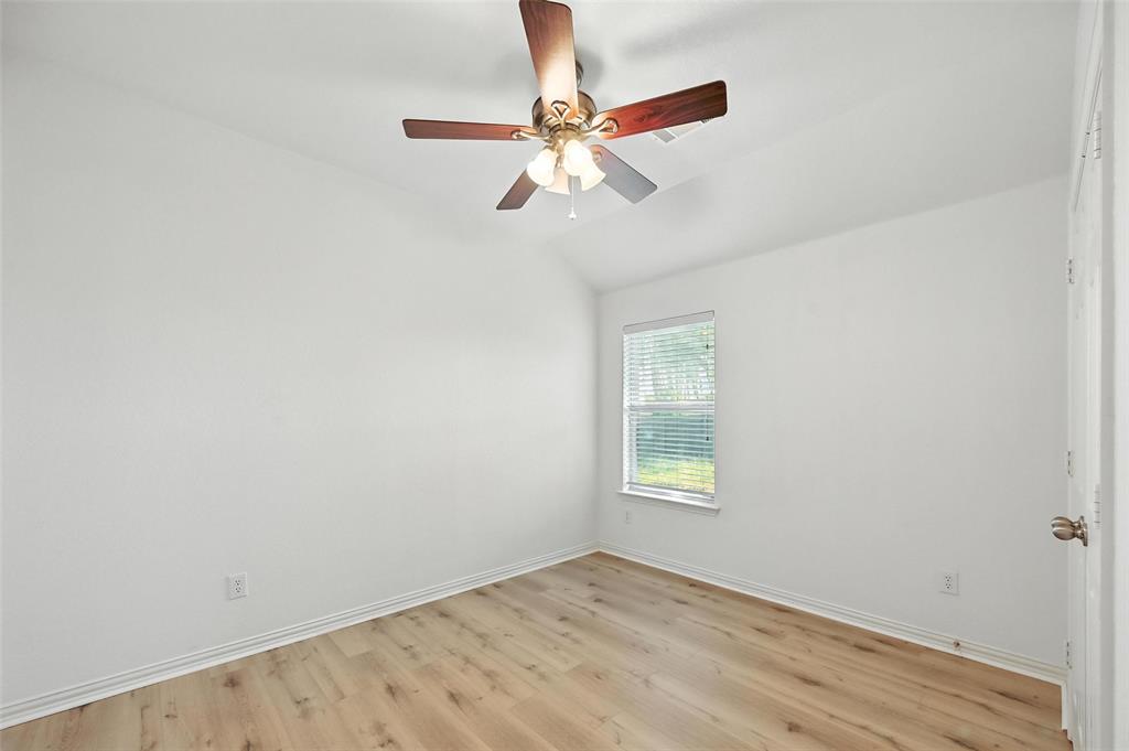 4312 Ridgewood Road Melissa, TX 75454 - Photo 7 of 40 an empty room with a window and a fan