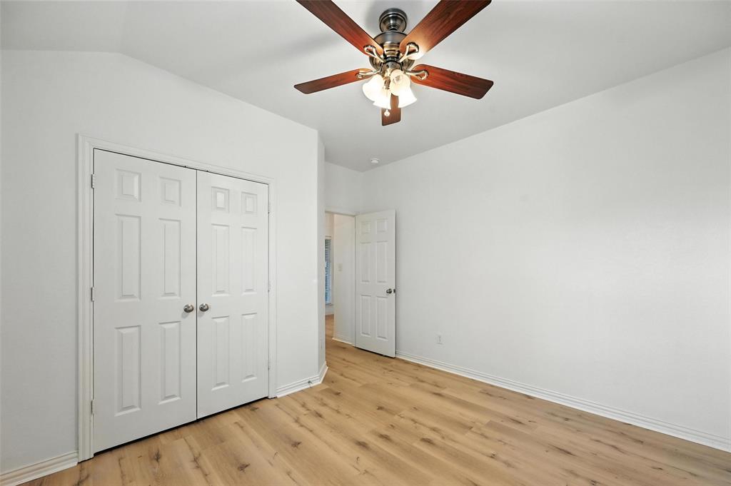 4312 Ridgewood Road Melissa, TX 75454 - Photo 8 of 40 an empty room with wooden floor fan and windows