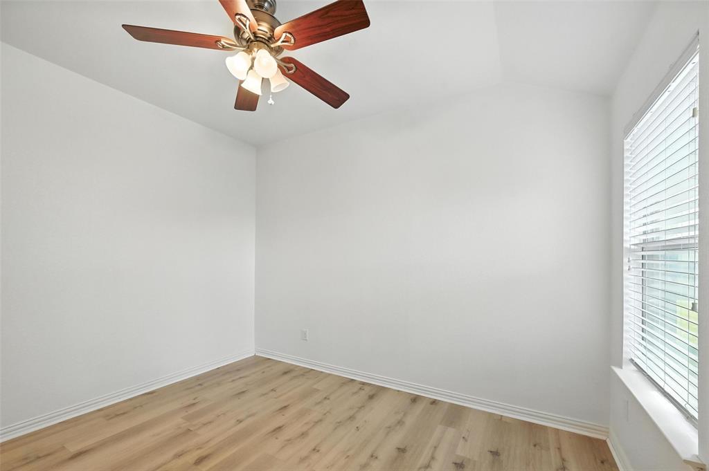 4312 Ridgewood Road Melissa, TX 75454 - Photo 9 of 40 an empty room with windows and fan