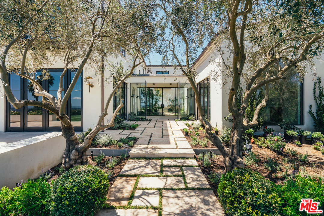 375 Fordyce Road Los Angeles, CA 90049 - Photo 18 of 26 a view of a large trees with flower plants and flower garden