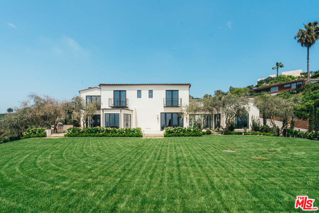 375 Fordyce Road Los Angeles, CA 90049 - Photo 21 of 26 a front view of a house with a garden