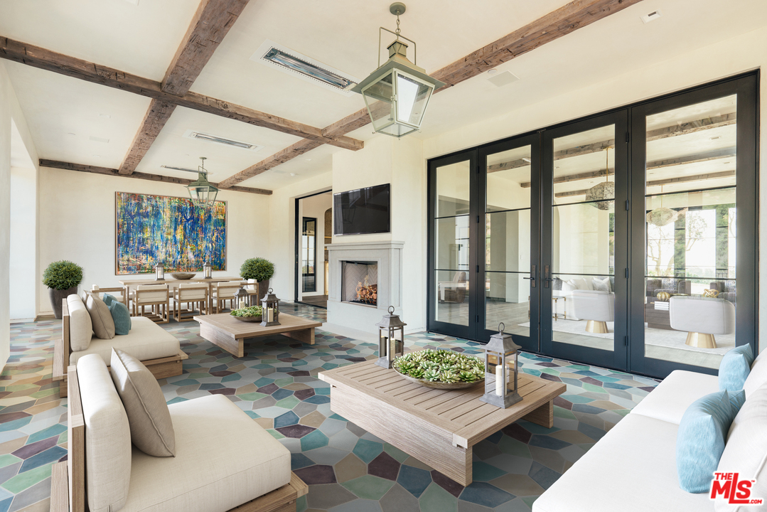375 Fordyce Road Los Angeles, CA 90049 - Photo 23 of 26 a living room with furniture large windows and wooden floor