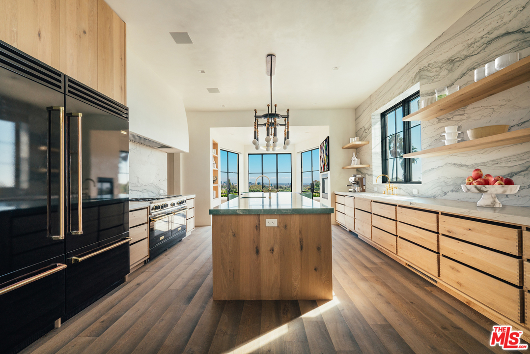 375 Fordyce Road Los Angeles, CA 90049 - Photo 6 of 26 a kitchen with stainless steel appliances granite countertop a stove a sink and a refrigerator