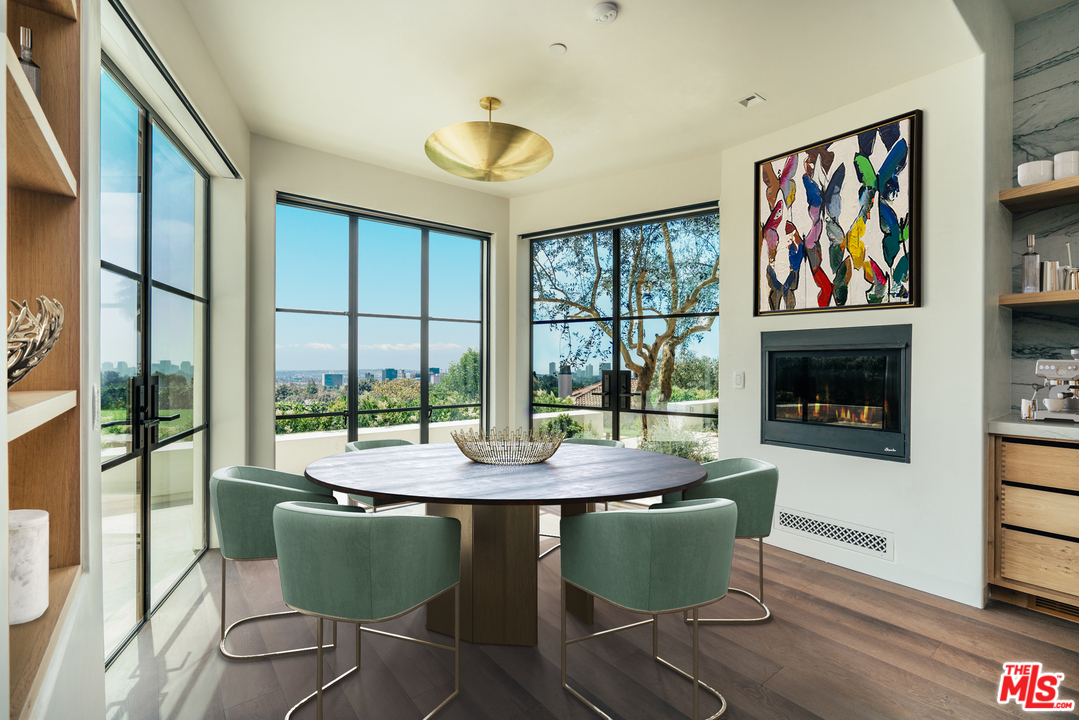 375 Fordyce Road Los Angeles, CA 90049 - Photo 7 of 26 a dining room with furniture a garden view and wooden floor