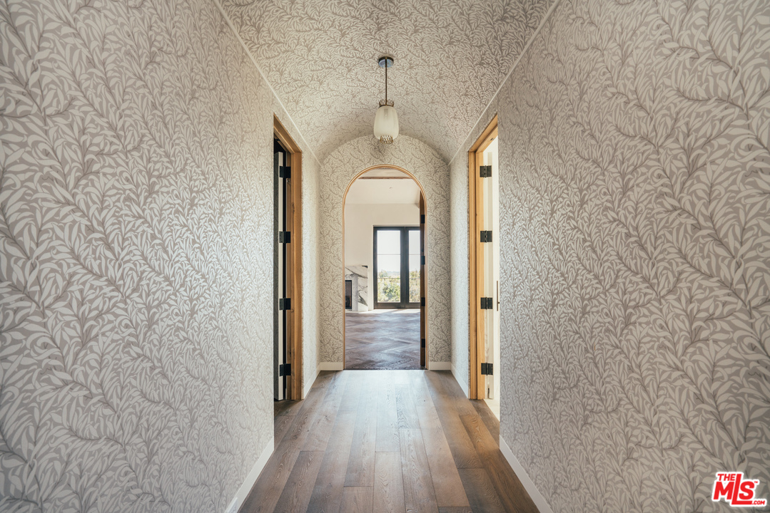 375 Fordyce Road Los Angeles, CA 90049 - Photo 10 of 26 a view of a hallway with wooden floor and staircase
