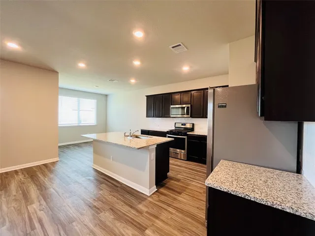 a view of an empty room and wooden floor