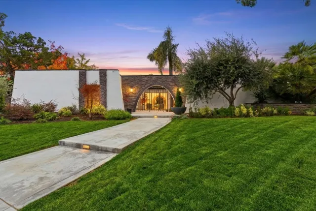 a front view of a house with garden