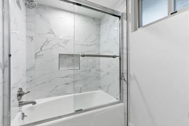 a bathroom with a sink a mirror and a shower