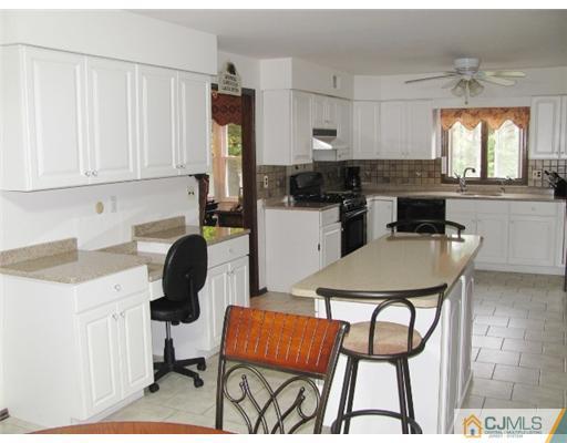 201 Raymond Road Princeton, NJ 08540 - Photo 4 of 10 a kitchen with a dining table chairs and a refrigerator
