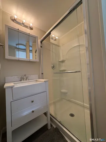 a bathroom with a shower and sink
