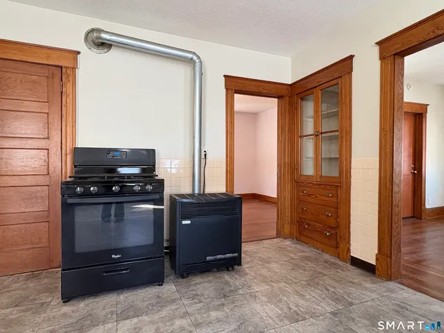a kitchen with a refrigerator and a stove