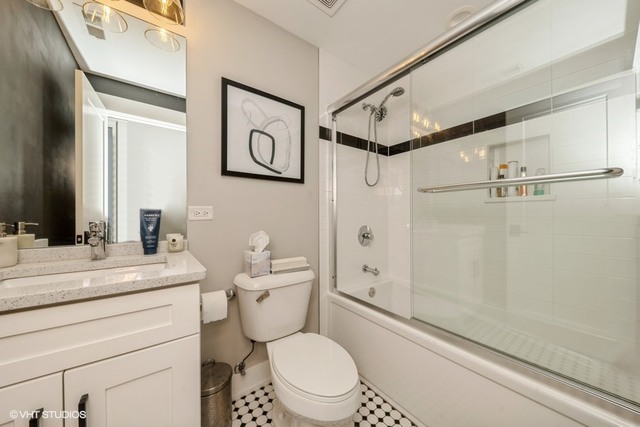 4730 South Champlain Avenue, Unit 3 Chicago, IL 60615 - Photo 14 of 16 a bathroom with a sink a toilet a mirror and shower