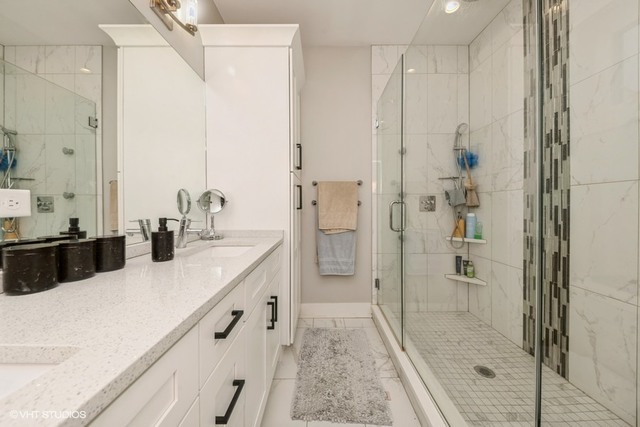 4730 South Champlain Avenue, Unit 3 Chicago, IL 60615 - Photo 15 of 16 a bathroom with double vanity and a shower