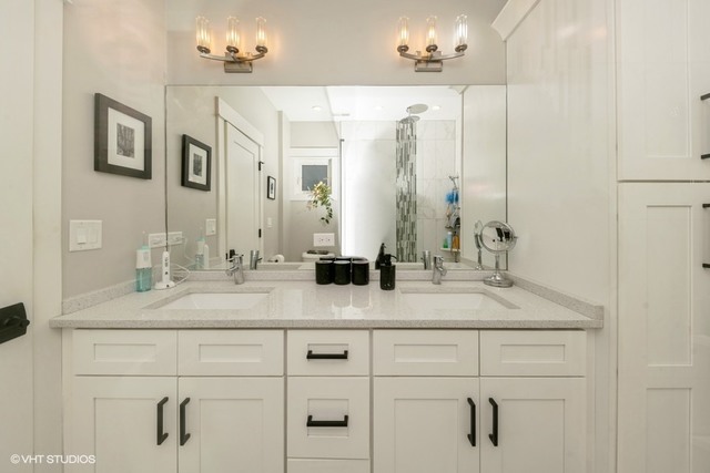 4730 South Champlain Avenue, Unit 3 Chicago, IL 60615 - Photo 16 of 16 a bathroom with double vanity sinks and a mirror