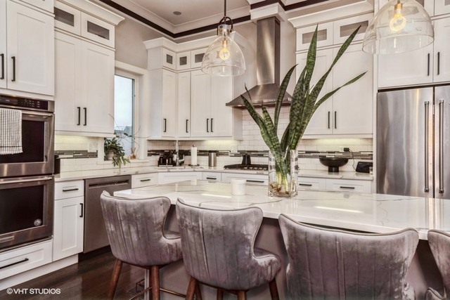 4730 South Champlain Avenue, Unit 3 Chicago, IL 60615 - Photo 6 of 16 a kitchen with stainless steel appliances granite countertop a sink dishwasher a refrigerator a stove and white cabinets with wooden floor