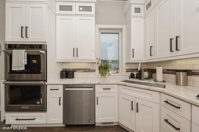 4730 South Champlain Avenue, Unit 3 Chicago, IL 60615 - Photo 9 of 16 a kitchen with white cabinets and sink