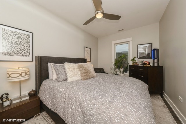 4730 South Champlain Avenue, Unit 3 Chicago, IL 60615 - Photo 10 of 16 a bedroom with a bed and dresser