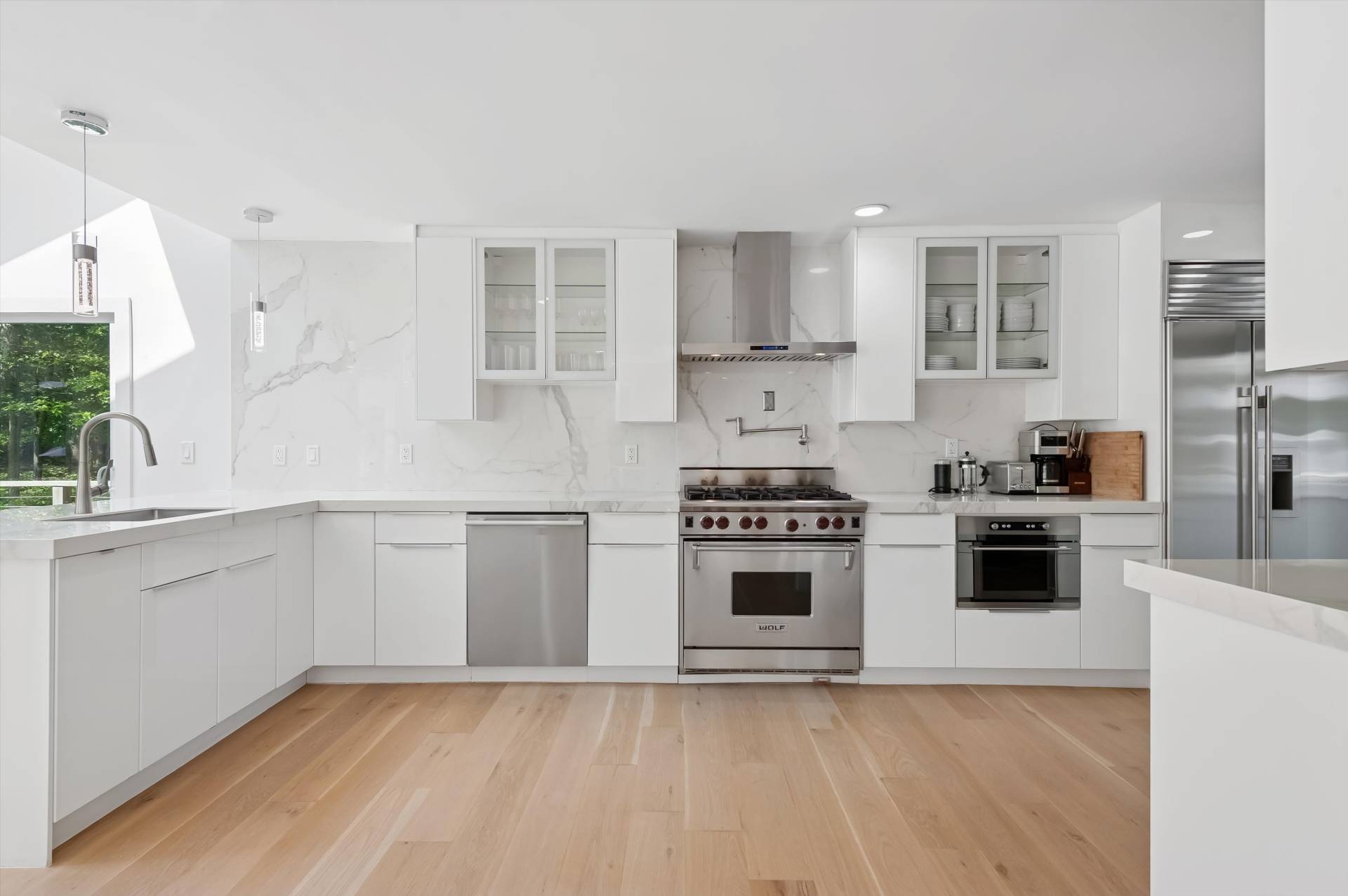 2 Jodys Path East Hampton, NY 11937 - Photo 22 of 43 a kitchen with stainless steel appliances a stove a sink and white cabinets