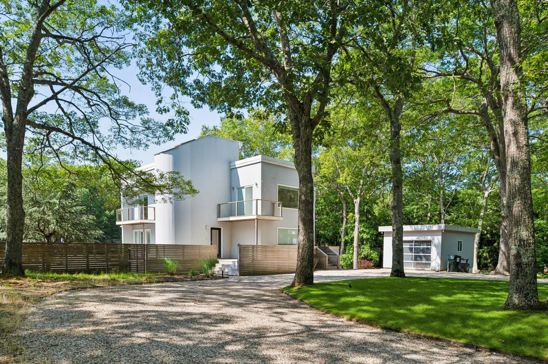 2 Jodys Path East Hampton, NY 11937 - Photo 5 of 43 a front view of a house with a yard and garage
