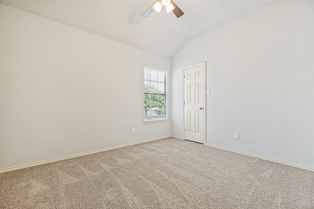 1215 Spring Creek Drive Allen, TX 75002 - Photo 22 of 40 Carpeted room featuring a vaulted ceiling and a ceiling fan