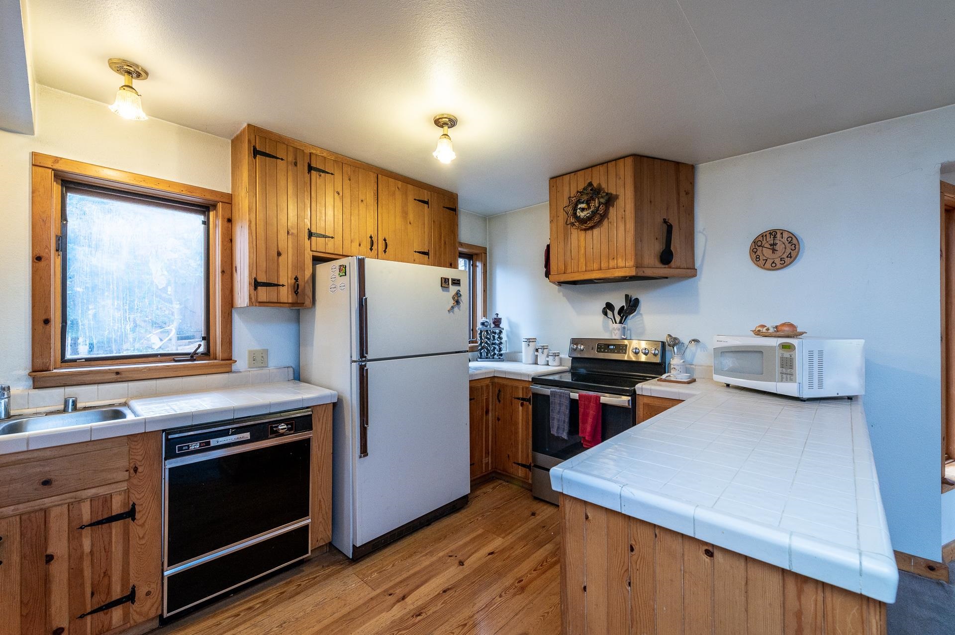 1191 Snow Crest Road Alpine Meadows, CA 96146 - Photo 3 of 21 a kitchen with stainless steel appliances granite countertop a refrigerator a stove a sink and a microwave
