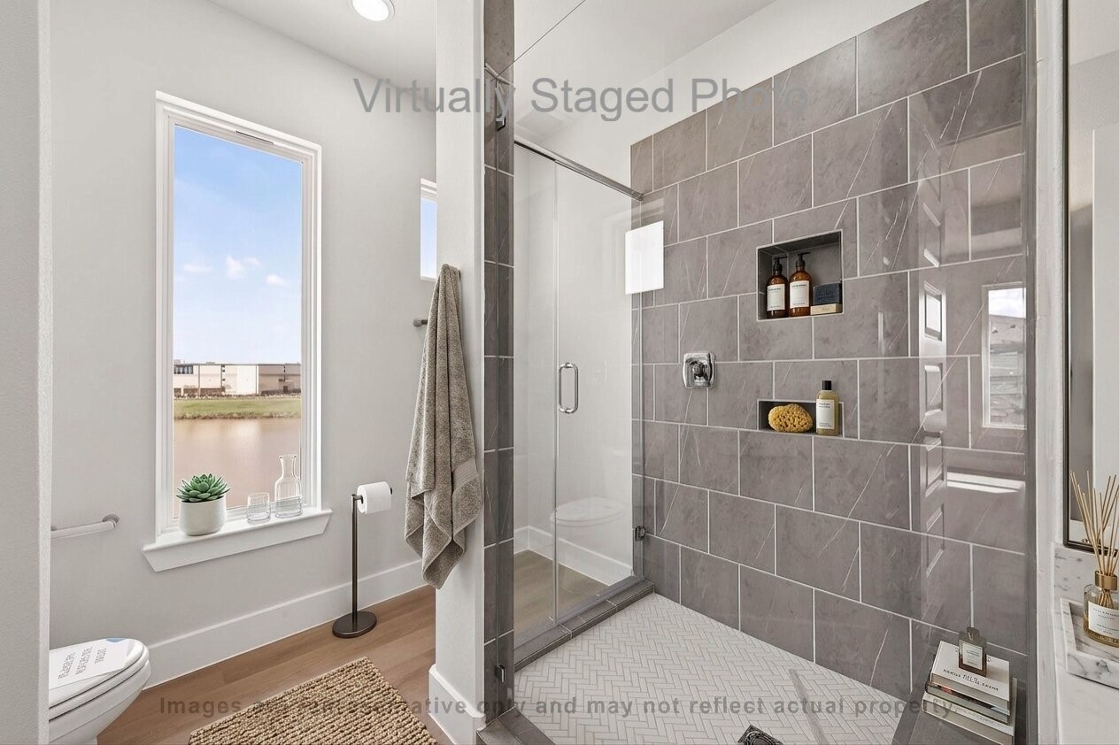 10719 Mason Road, Unit 15 Richmond, TX 77406 - Photo 26 of 50 Virtual Staging - Spacious bedroom featuring a comfortable bed, a seating area with two gray armchairs, and a large window offering a view of the neighborhood