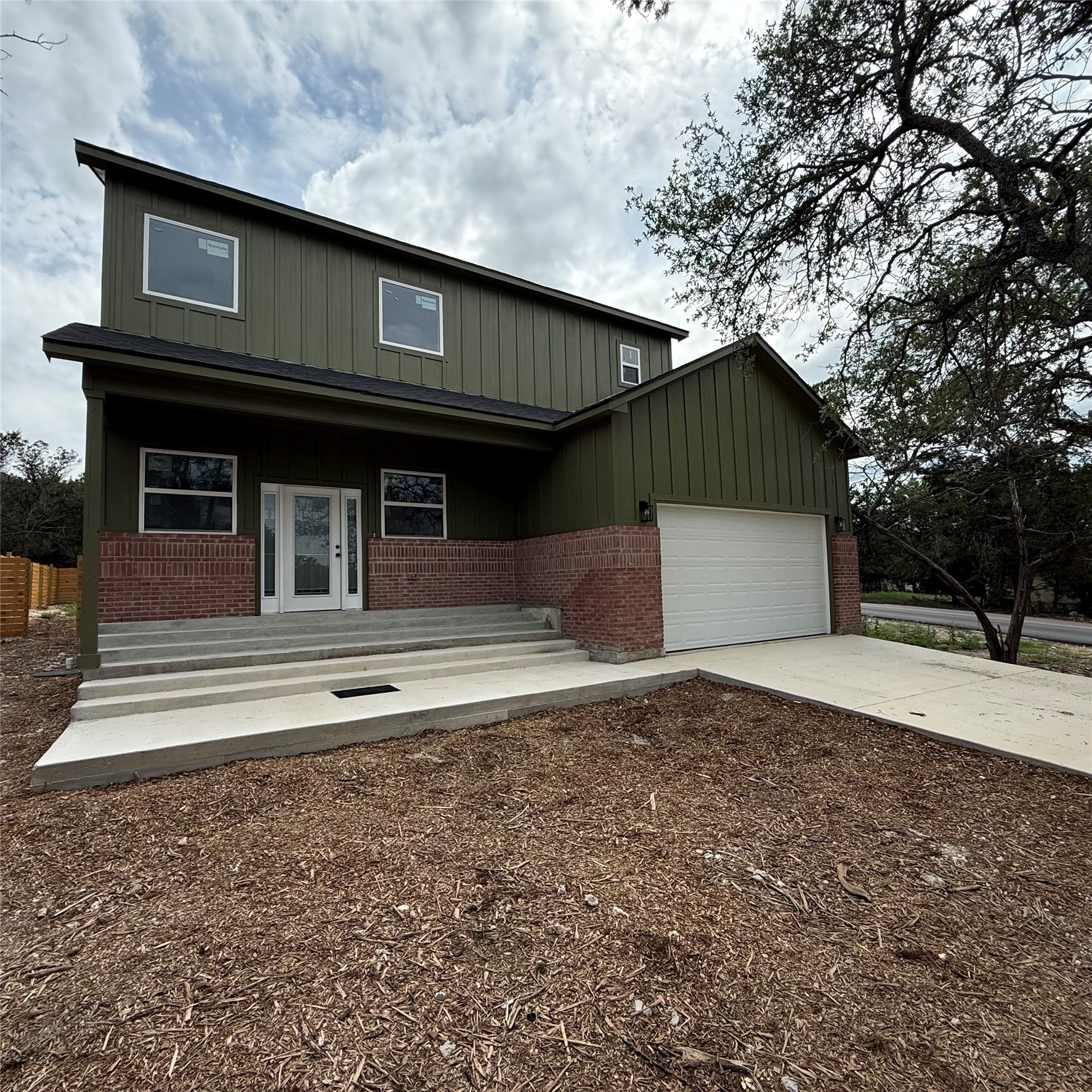 118 Crazy Cross Road Wimberley, TX 78676 - Photo 2 of 18 a front view of a house with a garage