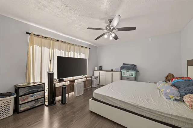 a bedroom with a bed furniture and a flat screen tv