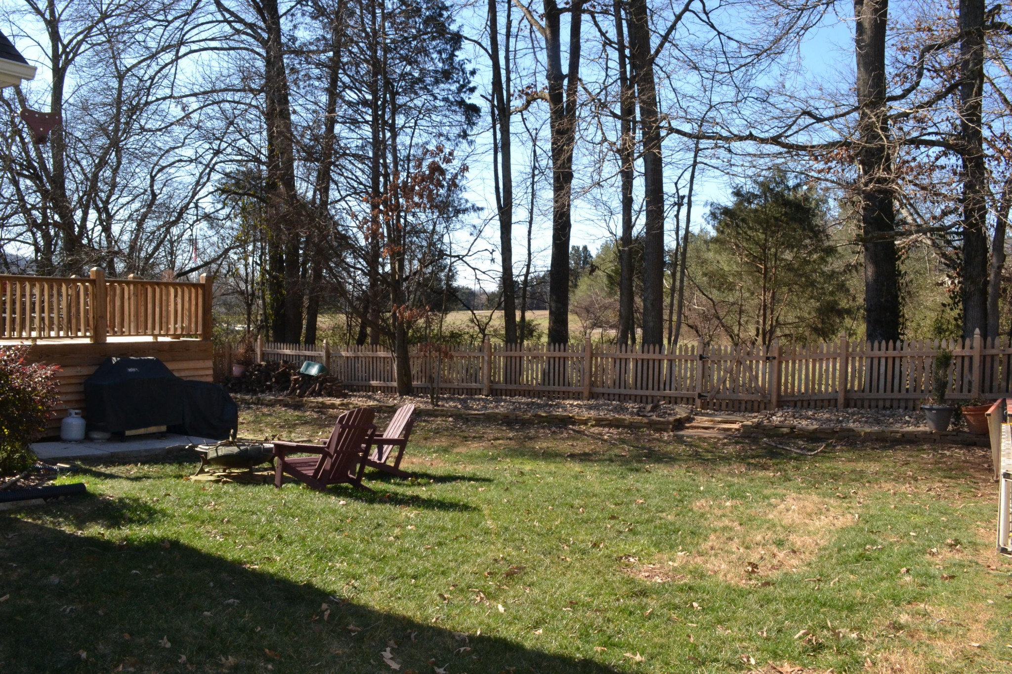929 Station View Road Knoxville, TN 37919 - Photo 24 of 33 a view of a backyard with table and chairs a barbeque and a large trees