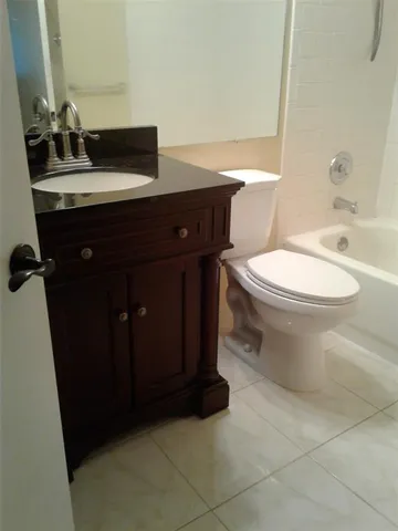a bathroom with a sink a toilet and vanity